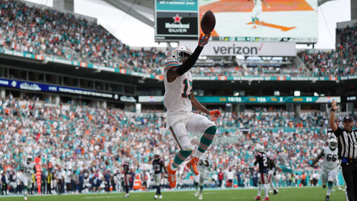 Miami Dolphins wide receiver Jaylen Waddle (17) flips the ball in the air as he scores a touchdown against the New England Patriots during the second half of an NFL game at Hard Rock Stadium in Miami Gardens, Oct. 29, 2023. Miami Dolphins wide receiver Jaylen Waddle (17) flips the ball in the air as he scores a touchdown against the New England Patriots during the second half of an NFL game at Hard Rock Stadium in Miami Gardens, Oct. 29, 2023.