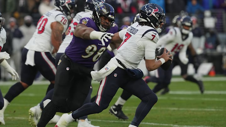 Jan 20, 2024; Baltimore, MD, USA; Houston Texans quarterback C.J. Stroud (7) runs the ball against Baltimore Ravens defensive tackle Travis Jones (98) during the first quarter of a 2024 AFC divisional round game at M&T Bank Stadium. Mandatory Credit: Mitch Stringer-Imagn Images