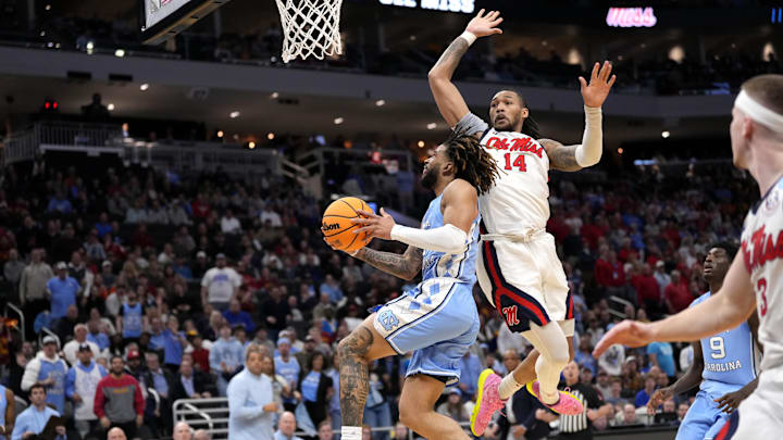 Mar 21, 2025; Milwaukee, WI, USA; North Carolina Tar Heels guard RJ Davis (4) drives against Mississippi Rebels guard Dre Davis (14) during the second half of a first round NCAA men’s tournament game at Fiserv Forum. Mandatory Credit: Jeff Hanisch-Imagn Images