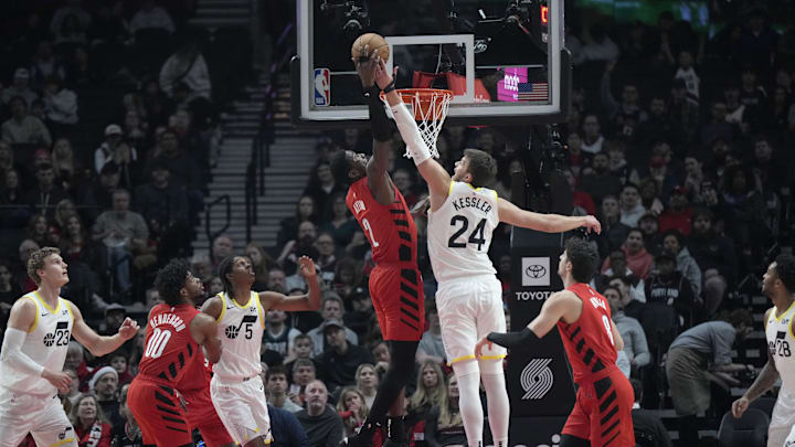 Dec 26, 2024; Portland, Oregon, USA; Portland Trail Blazers center Deandre Ayton (2) shoots the ball against Utah Jazz center Walker Kessler (24)  during the first half at Moda Center. Mandatory Credit: Soobum Im-Imagn Images