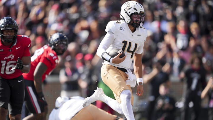 Oct 11, 2025; Cincinnati, Ohio, USA; UCF Knights quarterback Cam Fancher (14) carries the ball for a touchdown against the Cincinnati Bearcats in the second half at Nippert Stadium. Mandatory Credit: Aaron Doster-Imagn Images Oct 11, 2025; Cincinnati, Ohio, USA; UCF Knights quarterback Cam Fancher (14) carries the ball for a touchdown against the Cincinnati Bearcats in the second half at Nippert Stadium. Mandatory Credit: Aaron Doster-Imagn Images