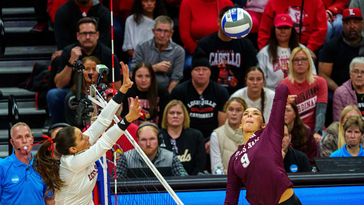 Dec 12, 2025; Lincoln, NE, USA; Texas A&M Aggies opposite Logan Lednicky (9) attacks against Louisville Cardinals outside hitter Chloe Chicoine (7) during the fifth set at Bob Devaney Sports Center. Mandatory Credit: Dylan Widger-Imagn Images Dec 12, 2025; Lincoln, NE, USA; Texas A&M Aggies opposite Logan Lednicky (9) attacks against Louisville Cardinals outside hitter Chloe Chicoine (7) during the fifth set at Bob Devaney Sports Center. Mandatory Credit: Dylan Widger-Imagn Images