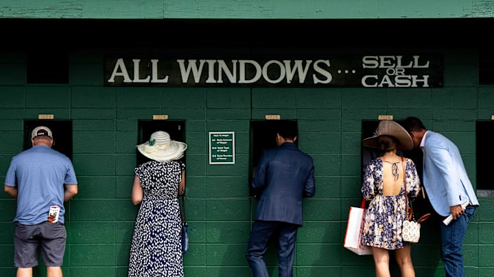 People place bets in the infield at Churchill Downs on Derby Day in Louisville, KY.