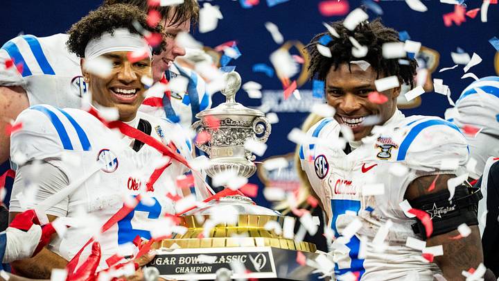 Ole Miss quarterback Trinidad Chambliss and running back Kewan Lacy pose with the Sugar Bowl trophy after the Sugar Bowl Ole Miss quarterback Trinidad Chambliss and running back Kewan Lacy pose with the Sugar Bowl trophy after the Sugar Bowl