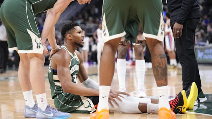 Dec 3, 2025; Milwaukee, Wisconsin, USA; Milwaukee Bucks forward Giannis Antetokounmpo (34) goes down with  an injury against the Detroit Pistons in the first half at Fiserv Forum. Mandatory Credit: Michael McLoone-Imagn Images
