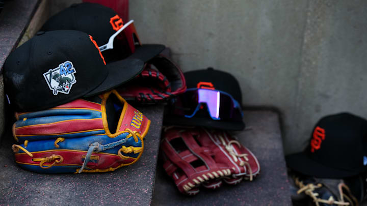 Apr 15, 2026; Cincinnati, Ohio, USA;  View of Giants game hats on the dugout steps, with a patch honoring Jackie Robinson during the game between the San Francisco Giants and the Cincinnati Reds at Great American Ball Park. Players and coaches will wear No. 42 in honor of Jackie Robinson Day around the league. Mandatory Credit: Aaron Doster-Imagn Images