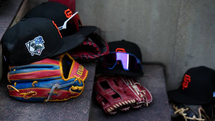 Apr 15, 2026; Cincinnati, Ohio, USA;  View of Giants game hats on the dugout steps, with a patch honoring Jackie Robinson during the game between the San Francisco Giants and the Cincinnati Reds at Great American Ball Park. Players and coaches will wear No. 42 in honor of Jackie Robinson Day around the league. Mandatory Credit: Aaron Doster-Imagn Images