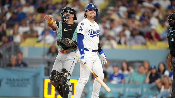 Aug 29, 2025; Los Angeles, California, USA; Los Angeles Dodgers third baseman Kike Hernandez (8) reacts after striking out in the third inning as Arizona Diamondbacks catcher James McCann (8) watches at Dodger Stadium. Mandatory Credit: Kirby Lee-Imagn Images