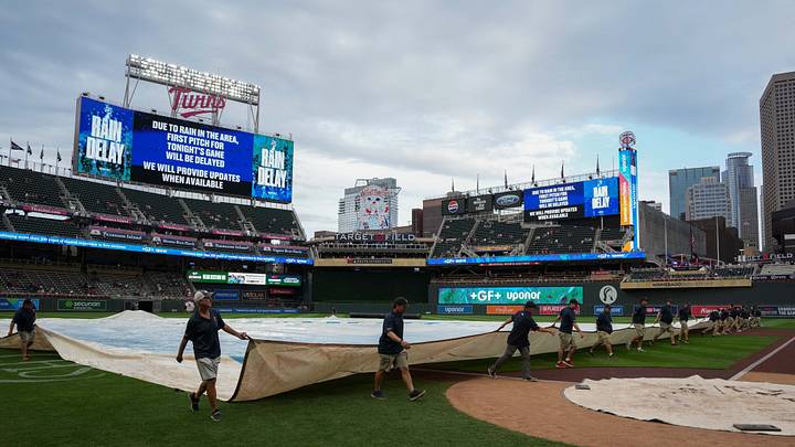 Aug 17, 2026; Minneapolis, Minnesota, USA; Members of the grounds crew pull the tarp onto the field during a rain delay before the start of the game between Atlanta Braves and Minnesota Twins at Target Field. Mandatory Credit: Jordan Johnson-Imagn Images