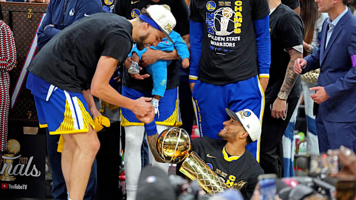 Jun 16, 2022; Boston, Massachusetts, USA; Golden State Warriors guard Gary Payton II (0) holds the the Larry O'Brien Championship Trophy and celebrates with guard Klay Thompson (11) after the Golden State Warriors beat the Boston Celtics in game six of the 2022 NBA Finals to win the NBA Championship at TD Garden. Mandatory Credit: Kyle Terada-USA TODAY Sports