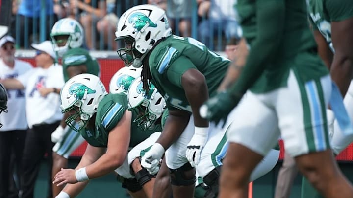Tulane’s offensive line prepares for the ensuing play.