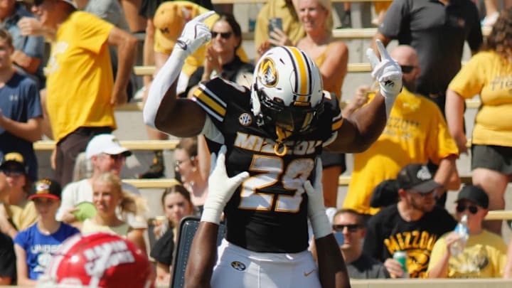 Sept 13, 2025; Columbia, Missouri, USA; Missouri Tigers left tackle Cayden Green lifts running back Ahmad Hardy in the first quarter at Faurot Field. 
