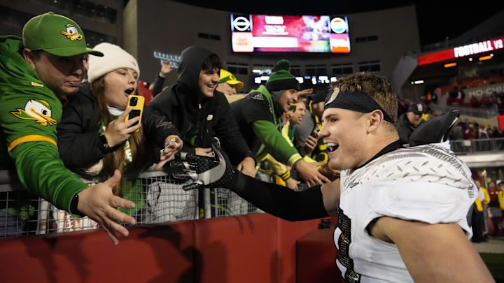 Nov 16, 2024; Madison, Wisconsin, USA;  Oregon Ducks linebacker Bryce Boettcher (28) celebrates with fans following the game against the Wisconsin Badgers at Camp Randall Stadium. Mandatory Credit: Jeff Hanisch-Imagn Images