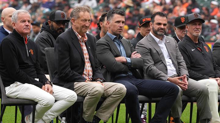 Apr 25, 2026; San Francisco, California, USA; (L to R) San Francisco Giants chairman Greg Johnson and president Larry Baer and president of baseball operations Buster Posey and general manager Zack Minasian sit on the field before the game against the Miami Marlins at Oracle Park. Mandatory Credit: Darren Yamashita-Imagn Images
