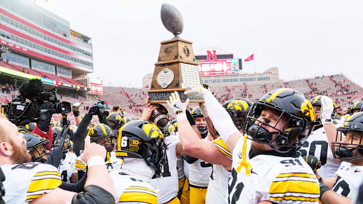 Nov 28, 2025; Lincoln, Nebraska, USA; The Iowa Hawkeyes hoist the Heroes Trophy after defeating the Nebraska Cornhuskers at Memorial Stadium. Mandatory Credit: Dylan Widger-Imagn Images