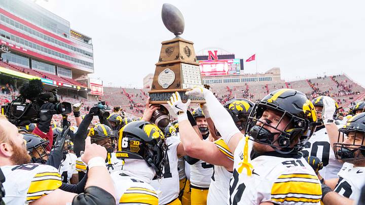 Nov 28, 2025; Lincoln, Nebraska, USA; The Iowa Hawkeyes hoist the Heroes Trophy after defeating the Nebraska Cornhuskers at Memorial Stadium. Mandatory Credit: Dylan Widger-Imagn Images Nov 28, 2025; Lincoln, Nebraska, USA; The Iowa Hawkeyes hoist the Heroes Trophy after defeating the Nebraska Cornhuskers at Memorial Stadium. Mandatory Credit: Dylan Widger-Imagn Images