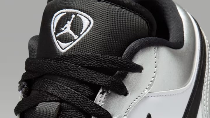 The Air Jordan 1 Low SE 'Metallic Silver Tiempo' colorway. The Air Jordan 1 Low SE 'Metallic Silver Tiempo' colorway.