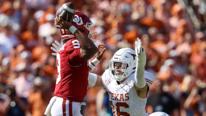 Oct 12, 2024; Dallas, Texas, USA;  Oklahoma Sooners quarterback Michael Hawkins Jr. (9) tries to throw as Texas Longhorns defensive back Michael Taaffe (16) defends during the first quarter at the Cotton Bowl. Mandatory Credit: Kevin Jairaj-Imagn Images
