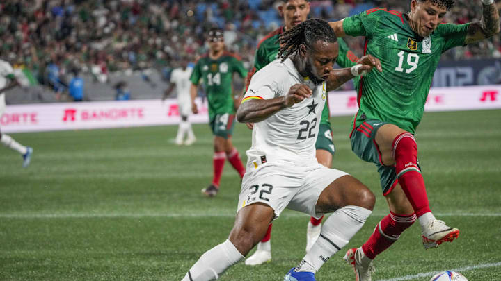 Oct 14, 2023; Charlotte, NC, USA; Ghana forward Antoine Semenyo (22) tries to hold off Mexico defender Jorge Sanchez (19) during the first half at Bank of America Stadium. Mandatory Credit: Jim Dedmon-Imagn Images