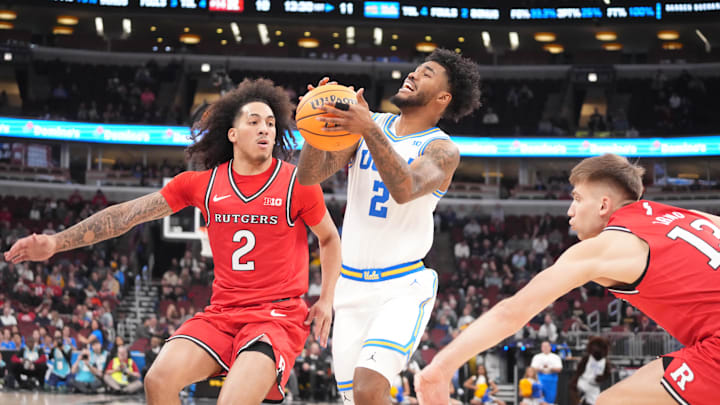 Mar 12, 2026; Chicago, IL, USA;UCLA Bruins guard Donovan Dent (2) is defended by Rutgers Scarlet Knights guard Lino Mark (2) during the first half at United Center. Mandatory Credit: David Banks-Imagn Images