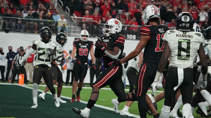 Dec 3, 2021; Las Vegas, NV, USA; Utah Utes running back Tavion Thomas (9) scores on a 2-yard