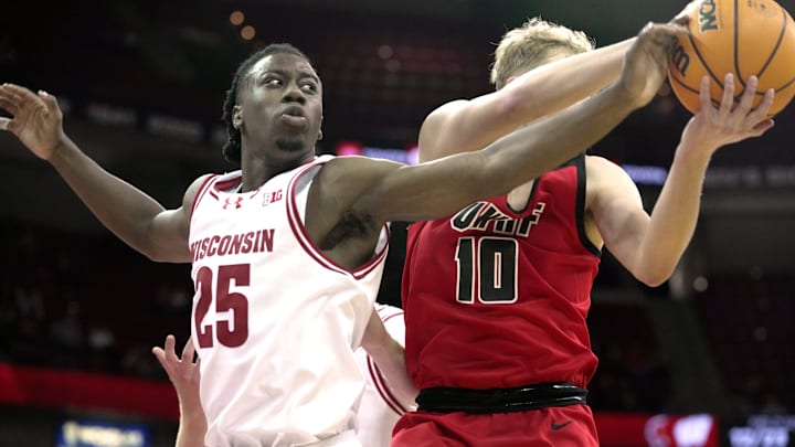 Wisconsin guard John Blackwell (25) tries to swat the all away from UW-River Falls guard Gavin Ralph (10) during the first half of their preseason game Wednesday, October 30, 2024 at the Kohl Center in Madison, Wisconsin.