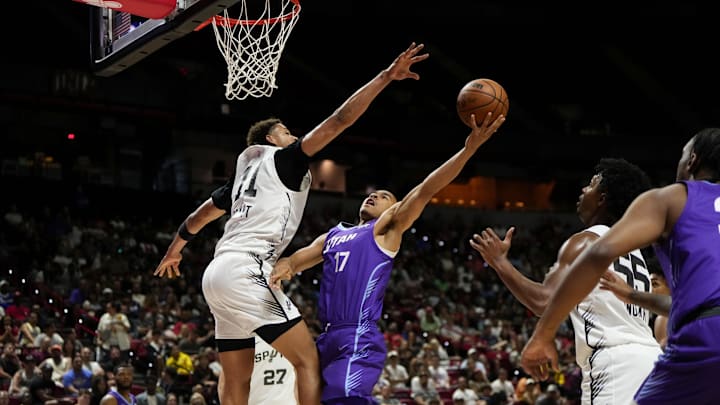 Jul 14, 2025; Las Vegas, NV, USA;  Utah Jazz forward John Tonje (17) drives towards the basket against San Antonio Spurs forward Carter Bryant (11) during the first half of a NBA basketball game at the Thomas & Mack Center. Mandatory Credit: Lucas Peltier-Imagn Images