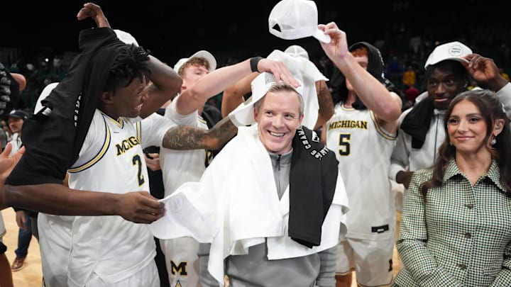 Nov 26, 2025; Las Vegas, NV, USA; Players celebrates with Michigan Wolverines head coach Dusty May after defeating the Gonzaga Bulldogs in the 2025 Players Era Festival championship game at MGM Grand Garden Arena. Mandatory Credit: Kirby Lee-Imagn Images