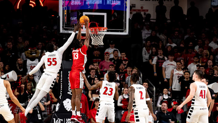 Ohio State Buckeyes forward Sean Stewart (13) dunks around Cincinnati Bearcats forward Aziz Bandaogo (55) in the first half of a basketball scrimmage between Cincinnati Bearcats and Ohio State Buckeyes at Fifth Third Arena in Cincinnati on Friday, Oct. 18, 2024.