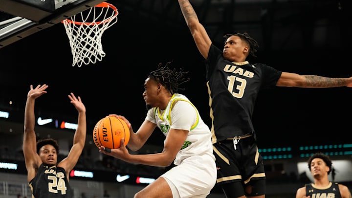 Mar 16, 2024; Fort Worth, TX, USA;  South Florida Bulls guard Kobe Knox (4) passes the ball between UAB Blazers guard Efrem Johnson (24) and Christian Coleman (13) during the first half at Dickies Arena. Mandatory Credit: Chris Jones-USA TODAY Sports
