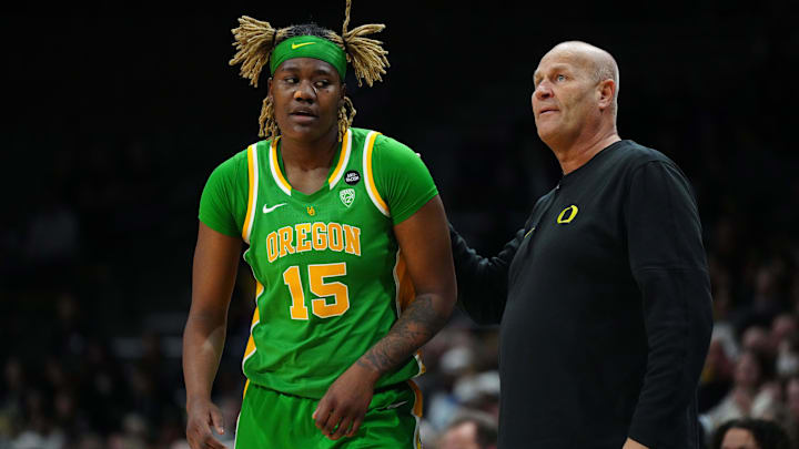 Feb 9, 2024; Boulder, Colorado, USA; Oregon Ducks center Phillipina Kyei (15) and head coach Kelly Graves.