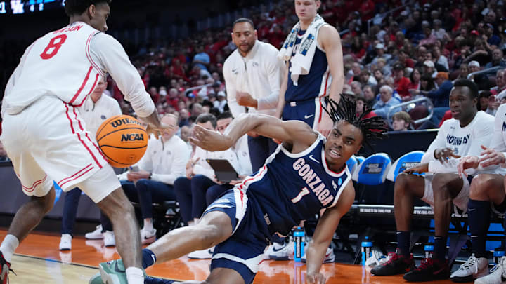 Mar 22, 2025; Wichita, KS, USA; Gonzaga Bulldogs guard Michael Ajayi (1) dives to keep the ball in play against Houston Cougars guard Mylik Wilson (8) during the first half at Intrust Bank Arena. Mandatory Credit: Kirby Lee-Imagn Images