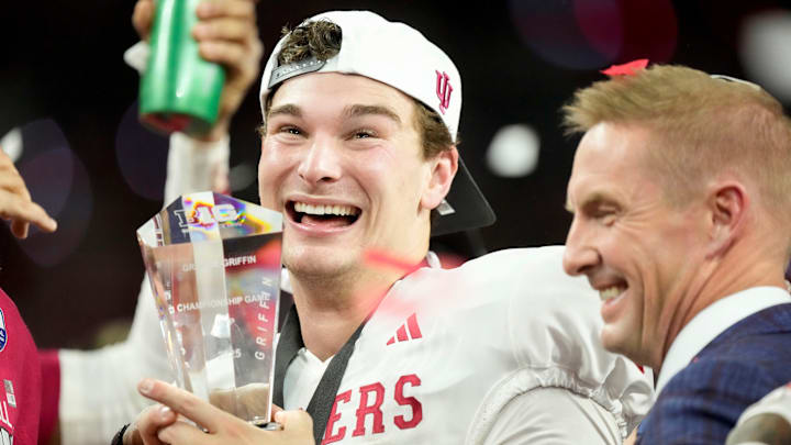 Indiana Hoosiers quarterback Fernando Mendoza (15) holds the MVP trophy on Sunday, Dec. 7, 2025, after winning the Big Ten football championship against the Ohio State Buckeyes at Lucas Oil Stadium in Indianapolis.