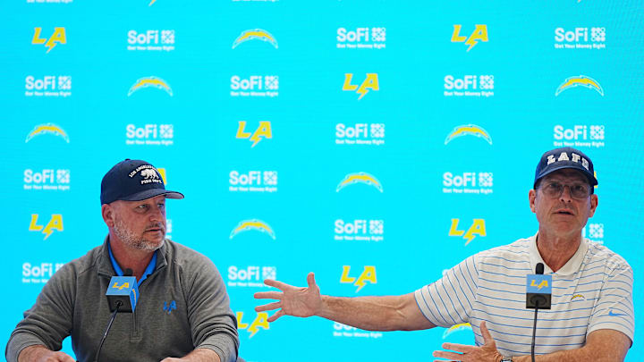 Jan 15, 2025; El Segundo, CA, USA; Los Angeles Chargers general manager Joe Hortiz (left) and coach Jim Harbaugh at a press conference at The Bolt. Mandatory Credit: Kirby Lee-Imagn Images