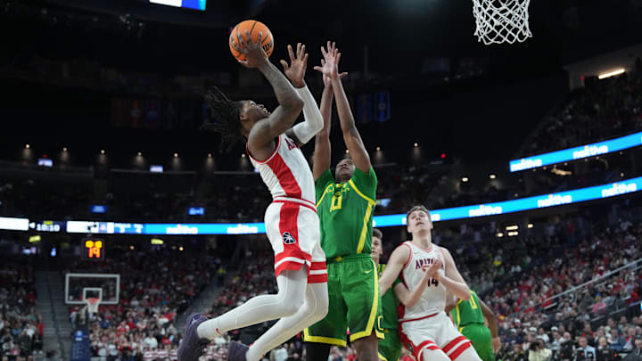 Mar 15, 2024; Las Vegas, NV, USA; Arizona Wildcats guard Caleb Love (2) shoots the ball against Oregon Ducks forward Kwame Evans Jr. (10) in the first half at T-Mobile Arena. Mandatory Credit: Kirby Lee-Imagn Images