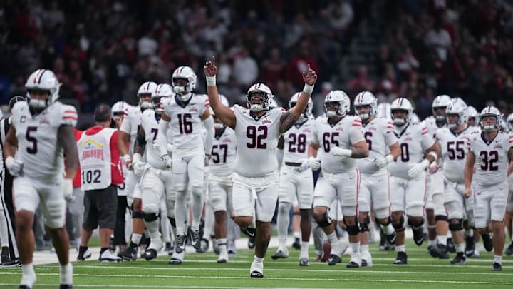 Dec 28, 2023; San Antonio, TX, USA;  Arizona Wildcats defensive lineman Tyler Manoa (92) leads the team out ahead of the game against the Oklahoma Sooners at Alamodome. Mandatory Credit: Daniel Dunn-Imagn Images Dec 28, 2023; San Antonio, TX, USA;  Arizona Wildcats defensive lineman Tyler Manoa (92) leads the team out ahead of the game against the Oklahoma Sooners at Alamodome. Mandatory Credit: Daniel Dunn-Imagn Images