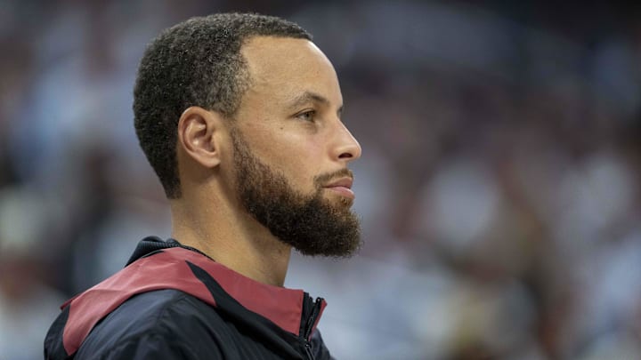 May 8, 2025; Minneapolis, Minnesota, USA; Golden State Warriors guard Stephen Curry (30) looks on from the bench against the Minnesota Timberwolves in the second half during game two of the second round for the 2025 NBA Playoffs at Target Center. Mandatory Credit: Jesse Johnson-Imagn Images