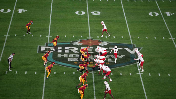 Dec 27, 2023; San Diego, CA, USA; A general overall view as Louisville Cardinals quarterback Jack Plummer (13) prepares to take the snap at the line of scrimmage against the Southern California Trojans on the Holiday Bowl logo at Petco Park. Mandatory Credit: Kirby Lee-USA TODAY Sports