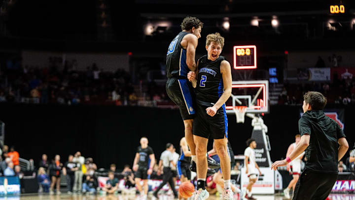 Waukee Northwest's Isaiah Oliver (20) and Mack Heitland (2) celebrate their semifinal win over Cedar Falls on Wednesday, March 12, 2025, at Wells Fargo Arena.