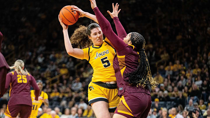 Iowa center Ava Heiden (5) keeps possession of the ball against Minnesota forward Finau Tonga (31) on Feb. 5, 2026, at Carver-Hawkeye Arena.