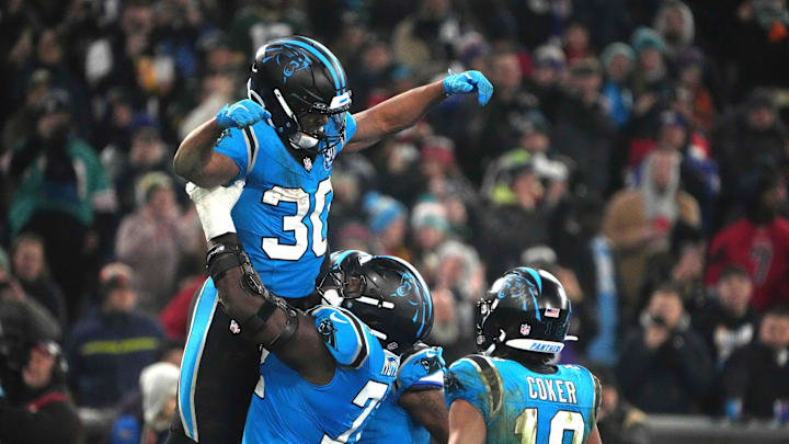 Nov 10, 2024; Munich, Germany; Carolina Panthers running back Chuba Hubbard (30) celebrates with offensive tackle Taylor Moton (72) and wide receiver Jalen Coker (18) after scoring on a 1-yard touchdown run against the New York Giants in the second half during the 2024 NFL Munich Game at Allianz Arena. Mandatory Credit: Kirby Lee-Imagn Images