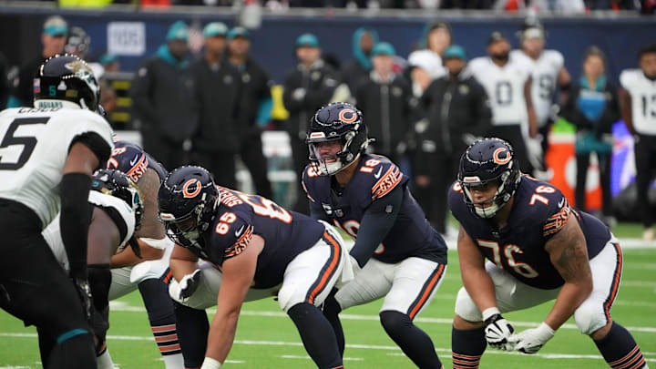 Oct 13, 2024; London, United Kingdom; Chicago Bears quarterback Caleb Williams (18) prepares to take the snap from center Coleman Shelton (65) as guard Teven Jenkins (76) watches against the Jacksonville Jaguars in the second half during an NFL International Series game at Tottenham Hotspur Stadium. Mandatory Credit: Kirby Lee-Imagn Images