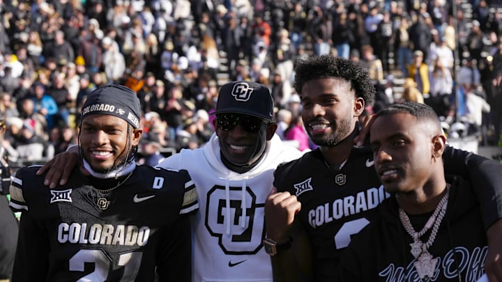 Nov 29, 2024; Boulder, Colorado, USA; Colorado Buffaloes safety Shilo Sanders (21) and head coach Deion Sanders and quarterback Shedeur Sanders (2) and social media producer Deion Sanders Jr. following the win against the Oklahoma State Cowboys at Folsom Field. Mandatory Credit: Ron Chenoy-Imagn Images