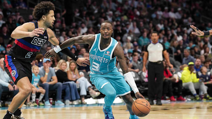 Oct 27, 2023; Charlotte, North Carolina, USA; Charlotte Hornets guard Terry Rozier (3) drives  against Cade Cunningham of the Detroit Pistons