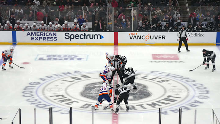 Mar 11, 2025; Los Angeles, California, USA; A general overall view as NHL referee  Eric Furlatt (27), drops the puck on the opening faceoff between New York Islanders center Jean-Gabriel Pageau (44) and LA Kings center Phillip Danault (24) on the Los Angeles Fire Dept. logo at center ice at the Crypto.com Arena. Mandatory Credit: Kirby Lee-Imagn Images