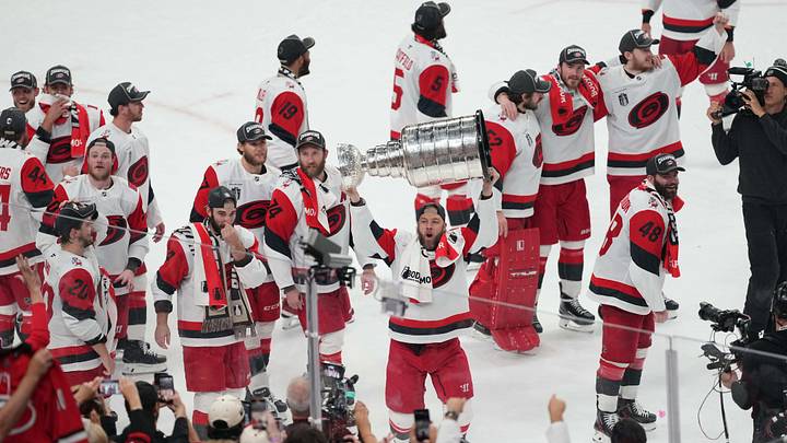 Jun 14, 2026; Las Vegas, Nevada, USA; Carolina Hurricanes celebrate with the Stanley Cup after defeating Vegas Golden Knights in game six of the 2026 Stanley Cup Final at T-Mobile Arena. Mandatory Credit: Lucas Peltier-Imagn Images