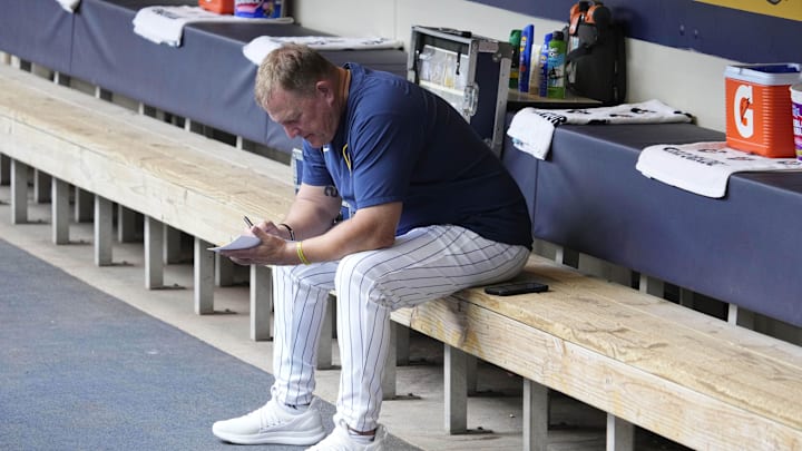 Jun 29, 2025; Milwaukee, Wisconsin, USA; Milwaukee Brewers manager Pat Murphy (49) works on his line card before their game against the Colorado Rockies at American Family Field. Mandatory Credit: Michael McLoone-Imagn Images