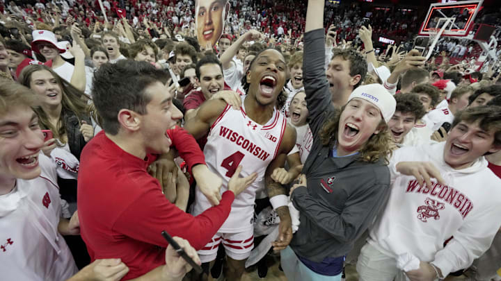 Wisconsin guard Kamari McGee (4) joins fans who stormed the court after their game Friday, November 15, 2024 at the Kohl Center in Madison, Wisconsin. Unranked Wisconsin upset Arizona 103-88. Wisconsin guard Kamari McGee (4) joins fans who stormed the court after their game Friday, November 15, 2024 at the Kohl Center in Madison, Wisconsin. Unranked Wisconsin upset Arizona 103-88.