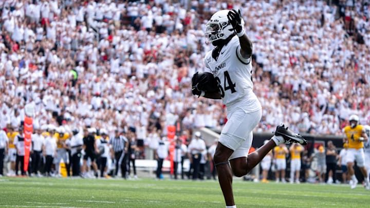 Cincinnati Bearcats wide receiver Sterling Berkhalter (84) gestures as he scores a touchdown in the first quarter of the College Football game between the Cincinnati Bearcats and the Towson Tigers at Nippert Stadium in Cincinnati on Saturday, Aug. 31, 2024.