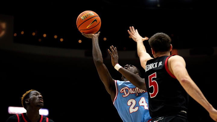 Dayton Flyers guard Kobe Elvis (24) draws a foul while shooting as Cincinnati Bearcats guard CJ Fredrick (5) covers him in the second half of the NCAA men's basketball game between the Dayton Flyers and Cincinnati Bearcats at Heritage Bank Center in Cincinnati on Saturday, Dec. 16, 2023. Dayton Flyers guard Kobe Elvis (24) draws a foul while shooting as Cincinnati Bearcats guard CJ Fredrick (5) covers him in the second half of the NCAA men's basketball game between the Dayton Flyers and Cincinnati Bearcats at Heritage Bank Center in Cincinnati on Saturday, Dec. 16, 2023.